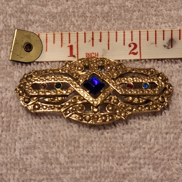 Jewelry - Vintage Gold Brooch with a Blue Gemstone Centerpiece.